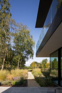 Architectural photography capturing the transition between indoor spaces and outdoor gardens.