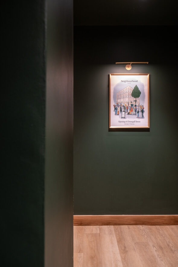 Subtle retail displays integrated with architectural features at Neighbourhood Café in Belfast, highlighting Crown Creative interiors.