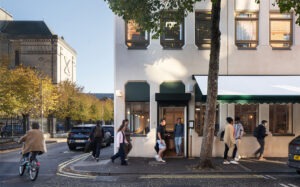 Early morning exterior of Neighbourhood Café in Belfast, showing a busy, vibrant coffee shop and welcoming street presence.