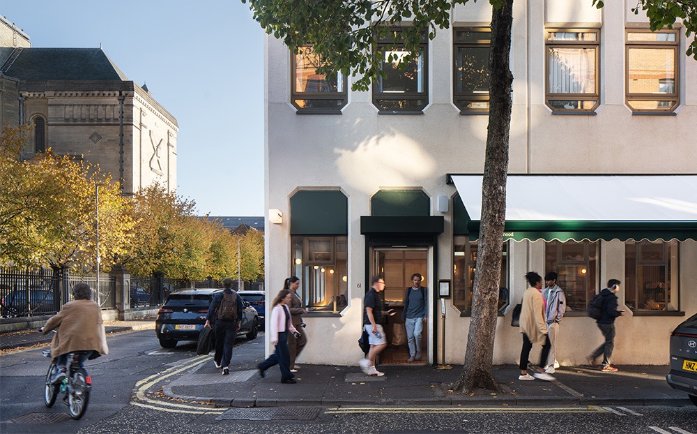 Early morning exterior of Neighbourhood Café in Belfast, showing a busy, vibrant coffee shop and welcoming street presence.
