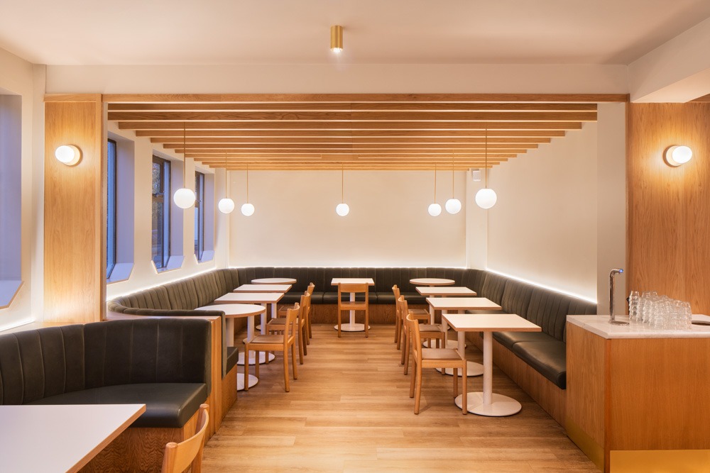 Generous booth seating and long banquettes at Neighbourhood Café, Belfast, showcasing strategic interior architectural design.