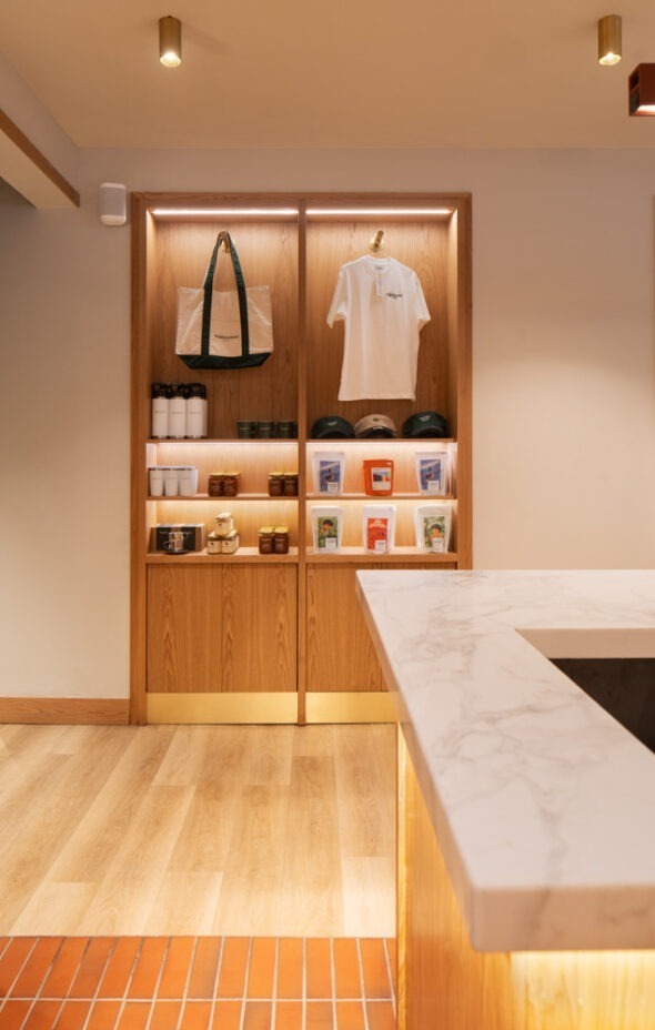 Subtle retail displays integrated with architectural features at Neighbourhood Café in Belfast, highlighting Crown Creative interiors.