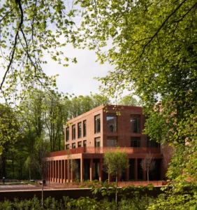Corner elevation of Queens Business School by Todd Architects, capturing award winning UK architecture and sensitive landscaped setting in context with historic Riddel Hall, photographed by Donal McCann Photography.