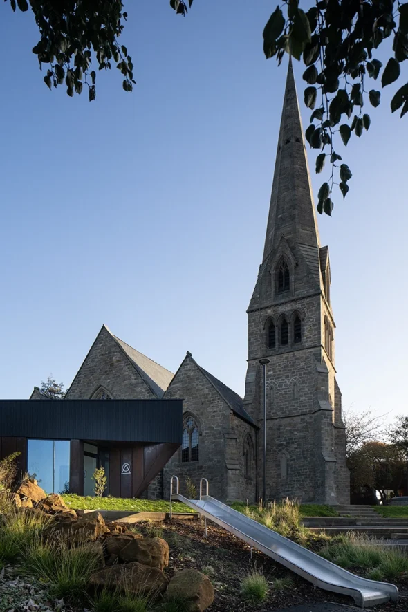 Wide-angle external shot of the refurbished church and modern extension within Byker Estate.