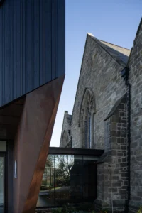 Architectural detail showing corten steel and timber complementing the old church interior in Byker.
