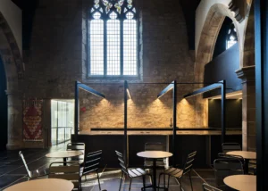 Interior view with stained glass and modern design features, demonstrating Bradley McClure Architects’ sensitive refurbishment.