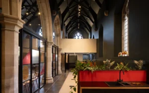 Interior of Lighthouse Project showing seamless blend of contemporary extension with historic church architecture.