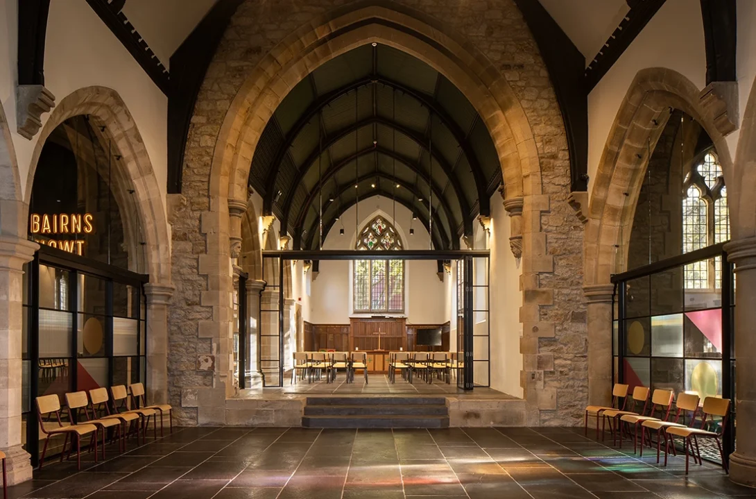 atural light streaming through the stained glass in the refurbished Lighthouse Project interior, highlighting modern interventions.