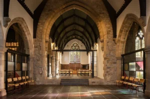 atural light streaming through the stained glass in the refurbished Lighthouse Project interior, highlighting modern interventions.
