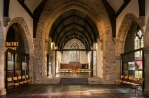 atural light streaming through the stained glass in the refurbished Lighthouse Project interior, highlighting modern interventions.