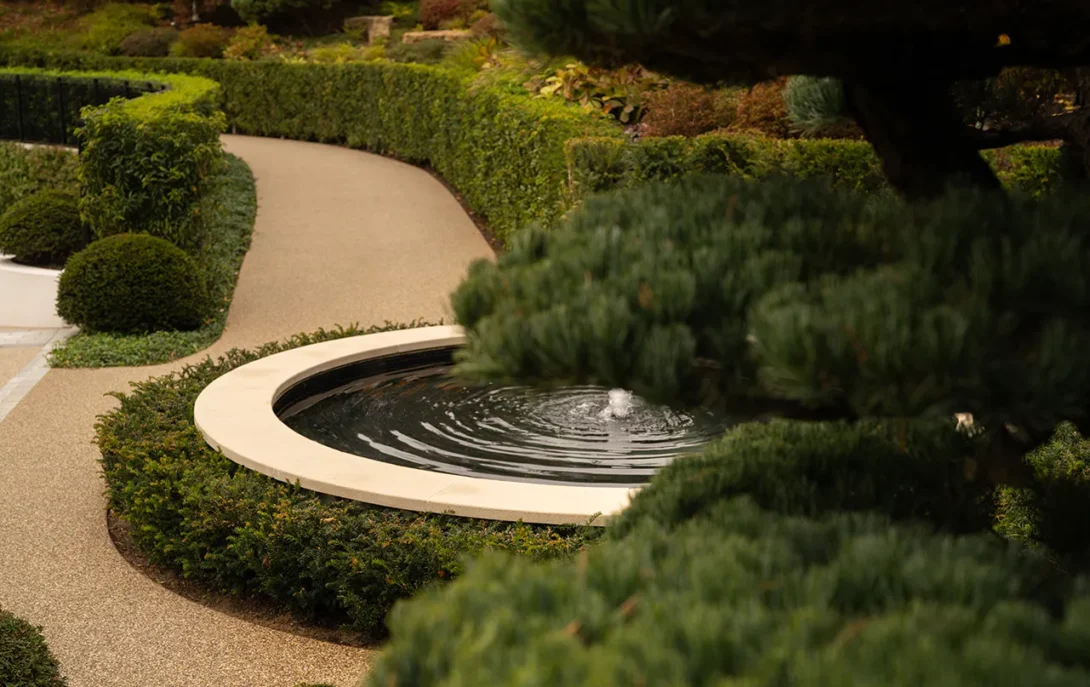 Stone and water composition showing elegant garden structure — UK landscape photography by architectural photographer.