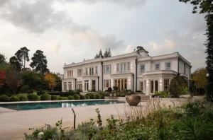 Contemporary Surrey home at dusk with illuminated pool — award winning UK landscape architectural photography.