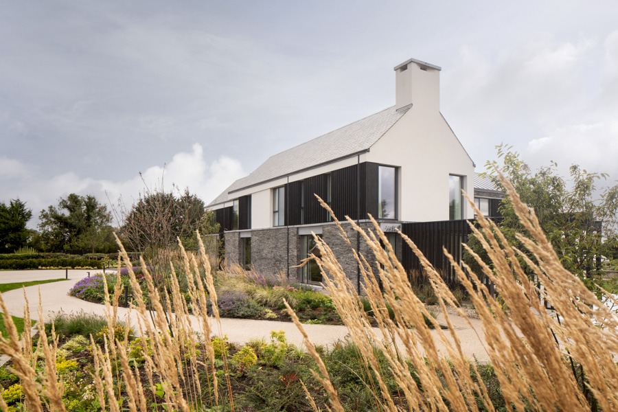 Modern family home by Nest Architects surrounded by considered landscaping at Washing Bay — UK architectural photography.