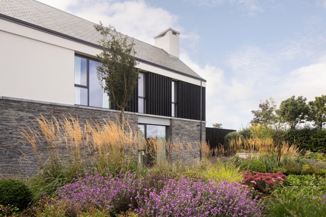 Exterior composition showing modern rural architecture and garden setting — UK architectural photography.