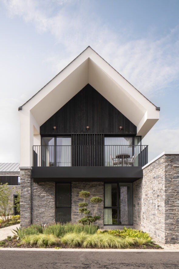 Evening light on Mountjoy House highlighting warm materials and landscape — architectural photography by UK architectural photographer.