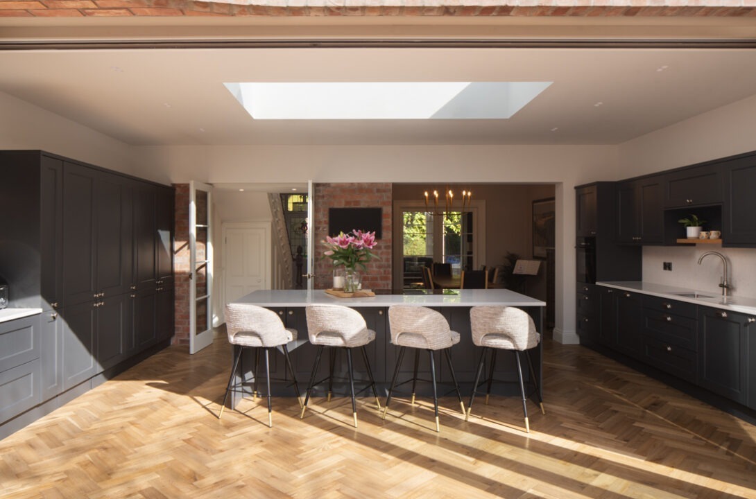 Exterior view of Nest Architects’ Belfast house renovation with bright rear addition and garden connection.