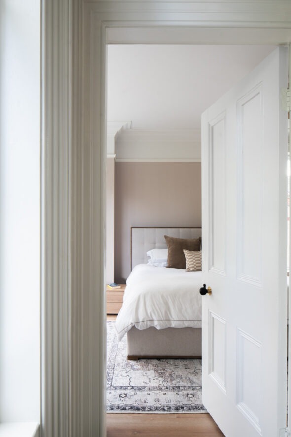 Main bedroom with soft pastel tones and natural light in Nest Architects’ Belfast house renovation — contemporary family home interior.