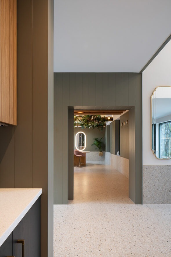 Interior corridor showing natural light streaming across modern finishes and textures in Nest Architects’ The Chalet.