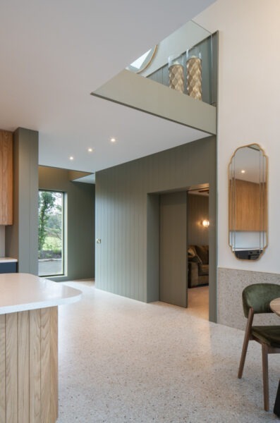 Interior corridor showing natural light streaming across modern finishes and textures in Nest Architects’ The Chalet.