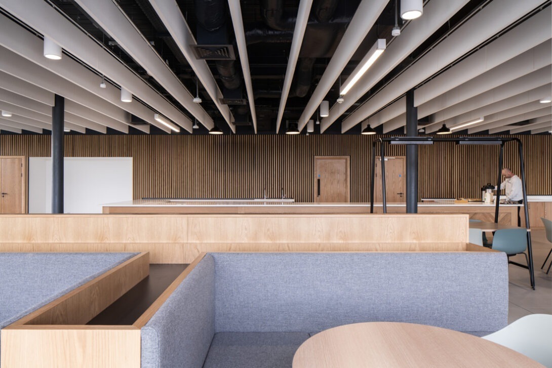 Contemporary workspace within AMIC combining industrial architecture with warm timber features.