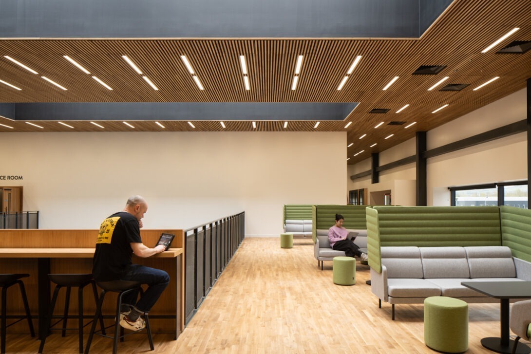 Modern breakout area at AMIC with timber finishes, comfortable seating and collaborative spaces.